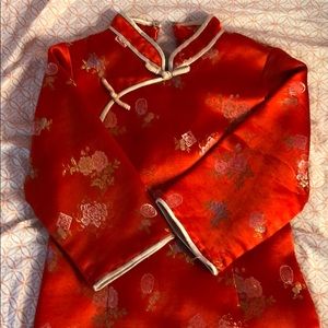 Red Chinese traditional dress with gold trim